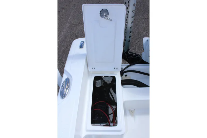 Slide: The Image of 2024 Clearwater 1900 CC boat storage compartment with open hatch, showing internal wiring. - 13