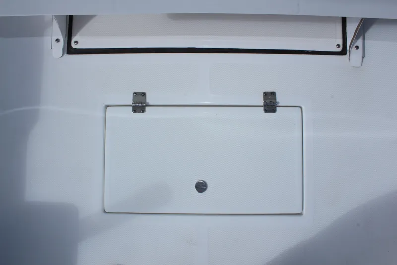 Slide: The Image of 2024 Clearwater 1900 CC boat storage compartment with secure latch and clean design. - 15