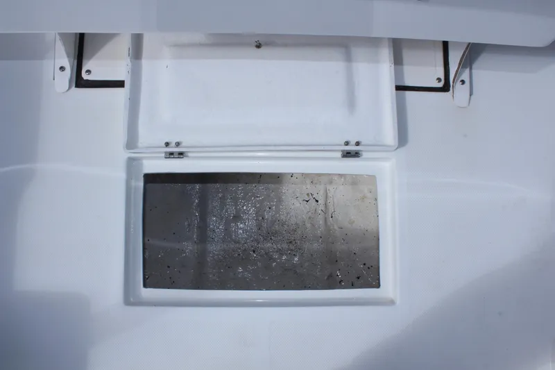 Slide: The Image of Open storage compartment on 2024 Clearwater 1900 CC boat deck. - 16