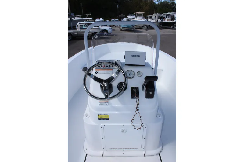 Slide: The Image of 2024 Clearwater 1900 CC boat console with steering wheel and navigation equipment. - 18
