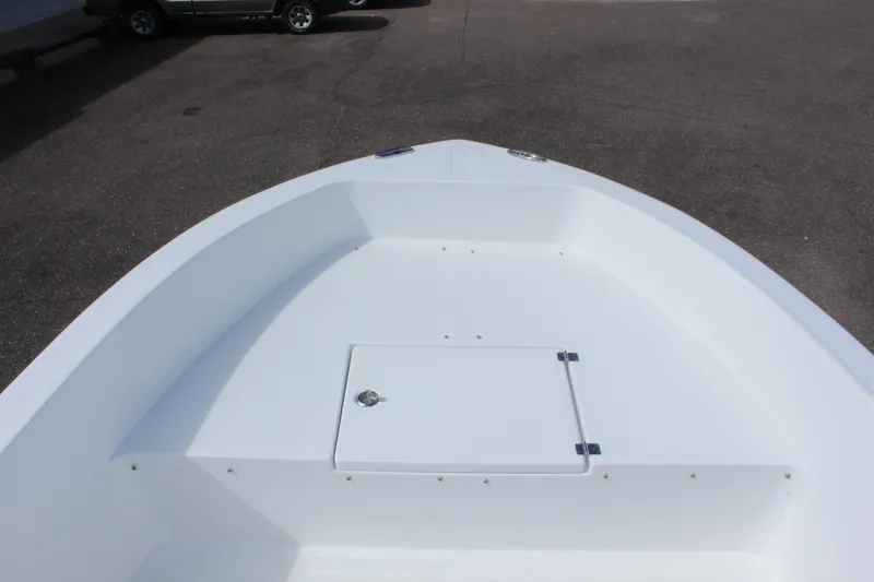 Slide: The Image of 2024 Clearwater 1900 CC boat deck, featuring a spacious white interior and storage compartment. - 22
