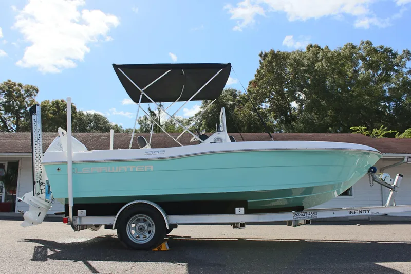 Slide: The Image of 2024 Clearwater 1900 CC boat on trailer, featuring a sleek design and canopy. - 6