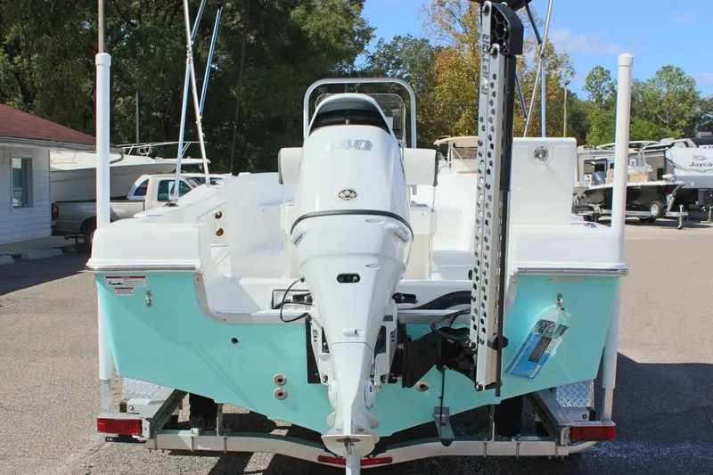 Slide: The Image of 2024 Clearwater 1900 CC boat with outboard motor, parked on a trailer. - 8