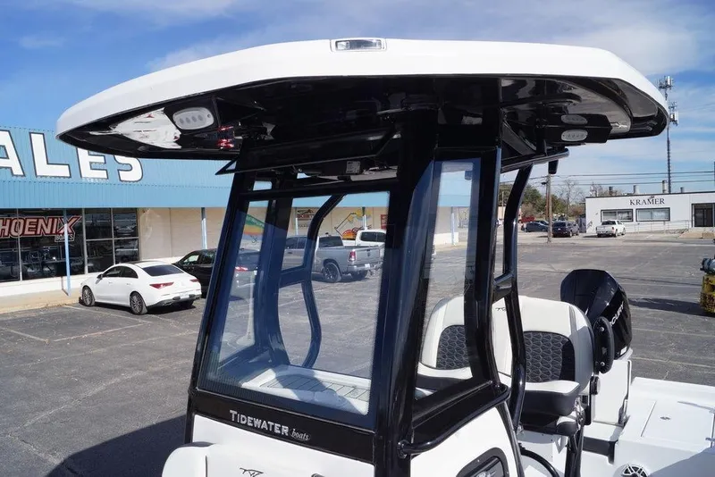 Slide: The Image of 2026 Tidewater 2410 Bay Max boat with sleek design in dealership lot. - 12