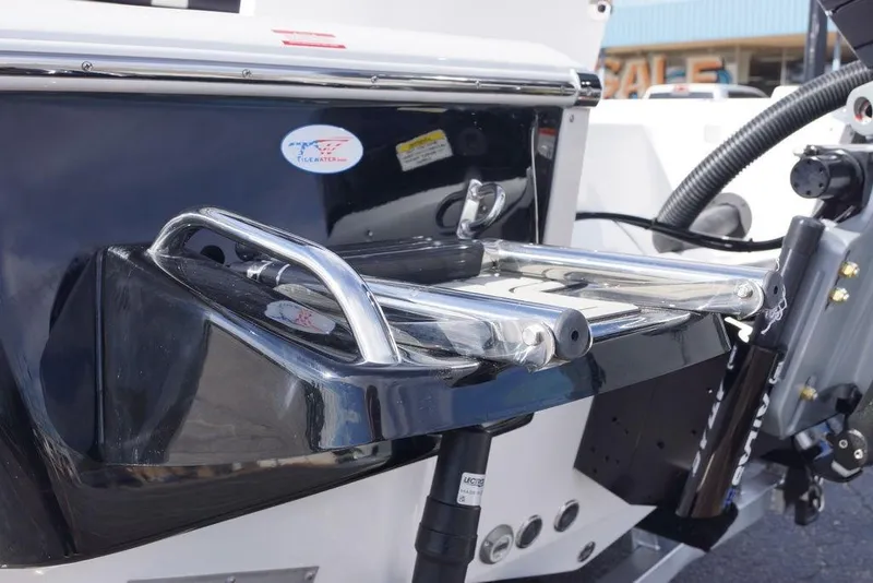 Slide: The Image of 2026 Tidewater 2410 Bay Max boat with stainless steel swim ladder and hydraulic components. - 13