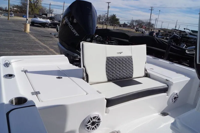 Slide: The Image of 2026 Tidewater 2410 Bay Max boat interior with cushioned seating and Mercury engine. - 14