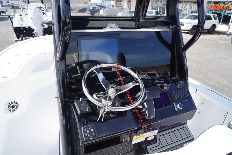 Slide: The Image of 2026 Tidewater 2410 Bay Max boat dashboard with steering wheel and controls. - 18
