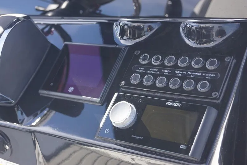 Slide: The Image of 2026 Tidewater 2410 Bay Max boat dashboard with control panel and Fusion audio system. - 19