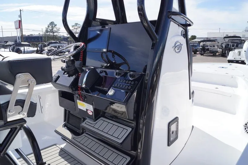 Slide: The Image of 2026 Tidewater 2410 Bay Max boat console with steering wheel and controls. - 20