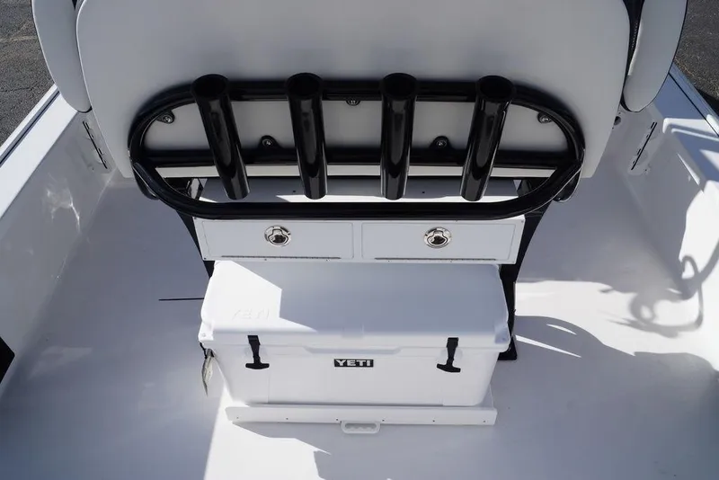 Slide: The Image of 2026 Tidewater 2410 Bay Max boat interior with rod holders and Yeti cooler. - 21