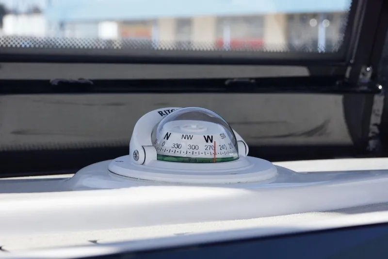Slide: The Image of Compass on 2026 Tidewater 2410 Bay Max boat dashboard, showing navigation directions. - 24