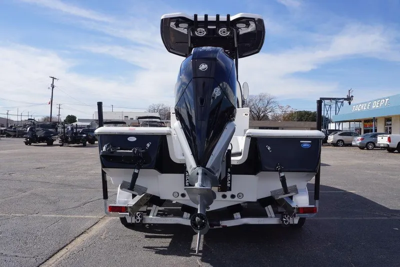 Slide: The Image of 2026 Tidewater 2410 Bay Max boat with powerful outboard motor in a parking lot. - 5