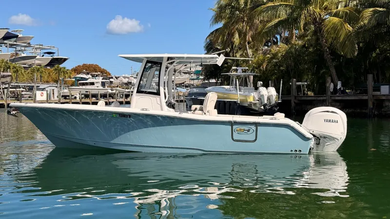 The Image of 2020 Sea Hunt Ultra 265 SE boat on water, palm trees in background. - 0