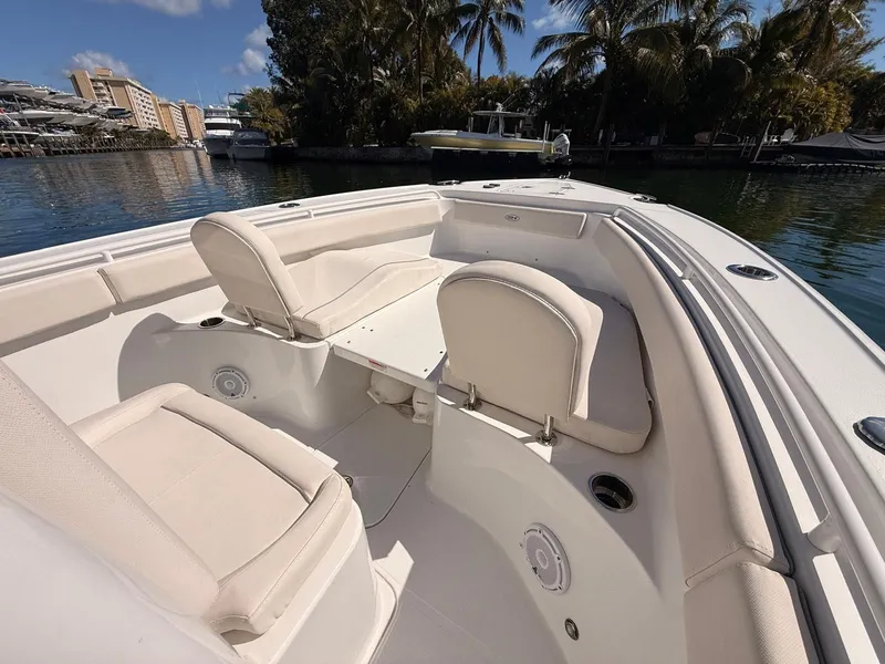 Slide: The Image of Interior of a 2020 Sea Hunt Ultra 265 SE boat by the water. - 12