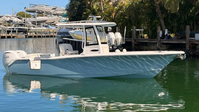 Slide: The Image of 2020 Sea Hunt Ultra 265 SE boat on water, side view. - 7