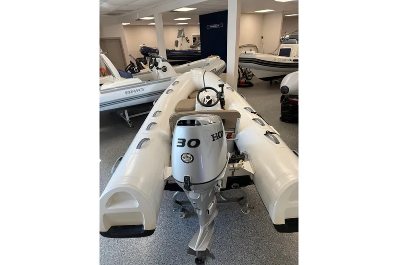 Slide: The Image of 2021 Brig Falcon 360 inflatable boat with Honda 30 HP engine in showroom. - 2