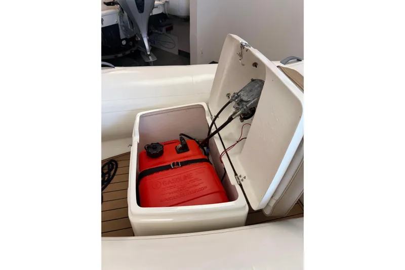 Slide: The Image of 2021 Brig Falcon 360 boat storage compartment with red gasoline tank. - 4