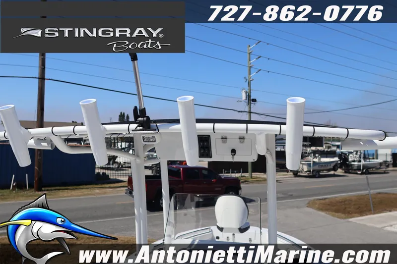 Slide: The Image of 2026 Stingray 216 CC boat with rod holders, displayed at Antonietti Marine. - 13