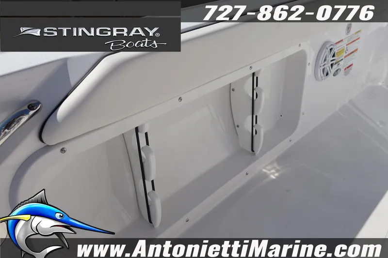 Slide: The Image of 2026 Stingray 216 CC boat interior with storage compartment and speaker. - 23