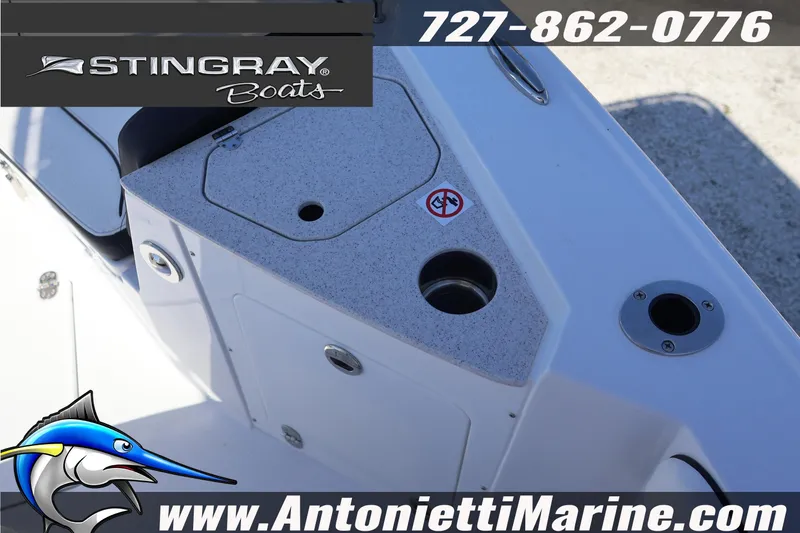 Slide: The Image of 2026 Stingray 216 CC boat deck with storage compartments and fishing rod holders. - 27