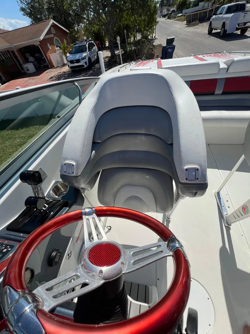 Slide: The Image of 2016 Formula 353 FASTech boat interior with red steering wheel and white seating. - 23