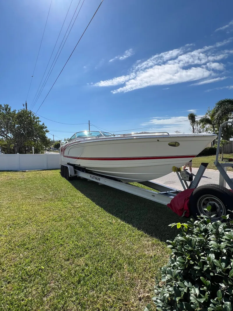 Slide: The Image of 2016 Formula 353 FASTech boat on trailer, parked on grass under a clear blue sky. - 3
