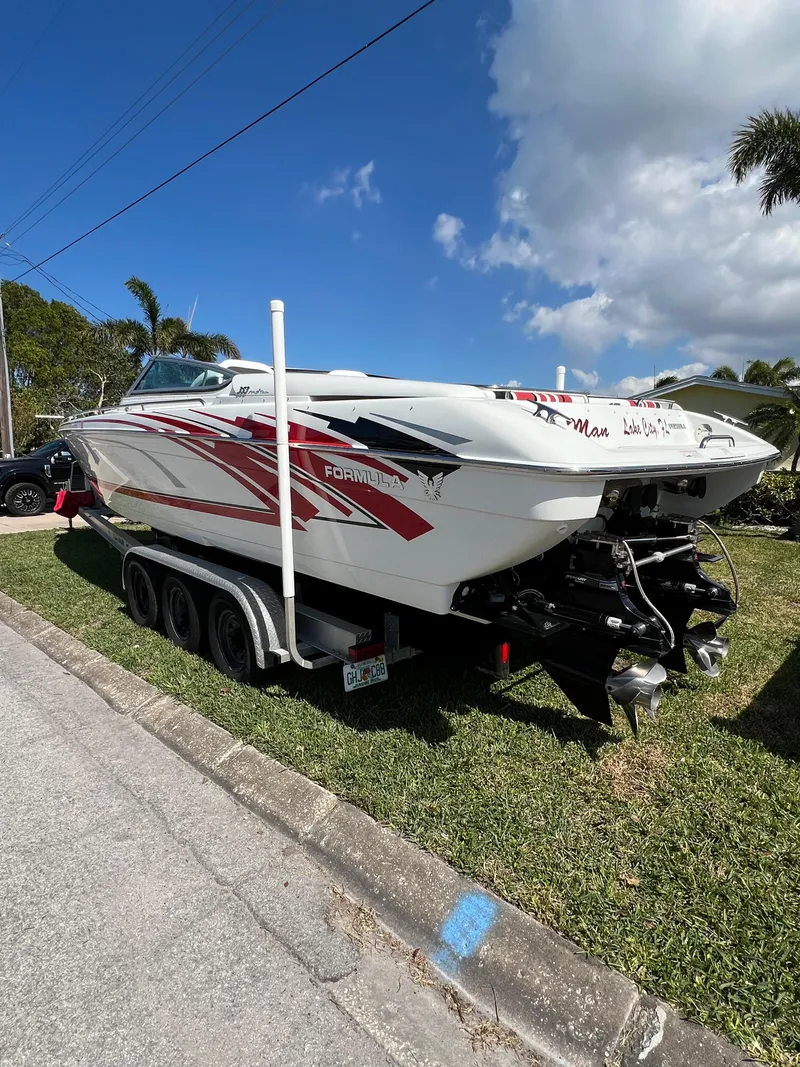 Slide: The Image of 2016 Formula 353 FASTech boat on trailer, parked on grass under a clear blue sky. - 5
