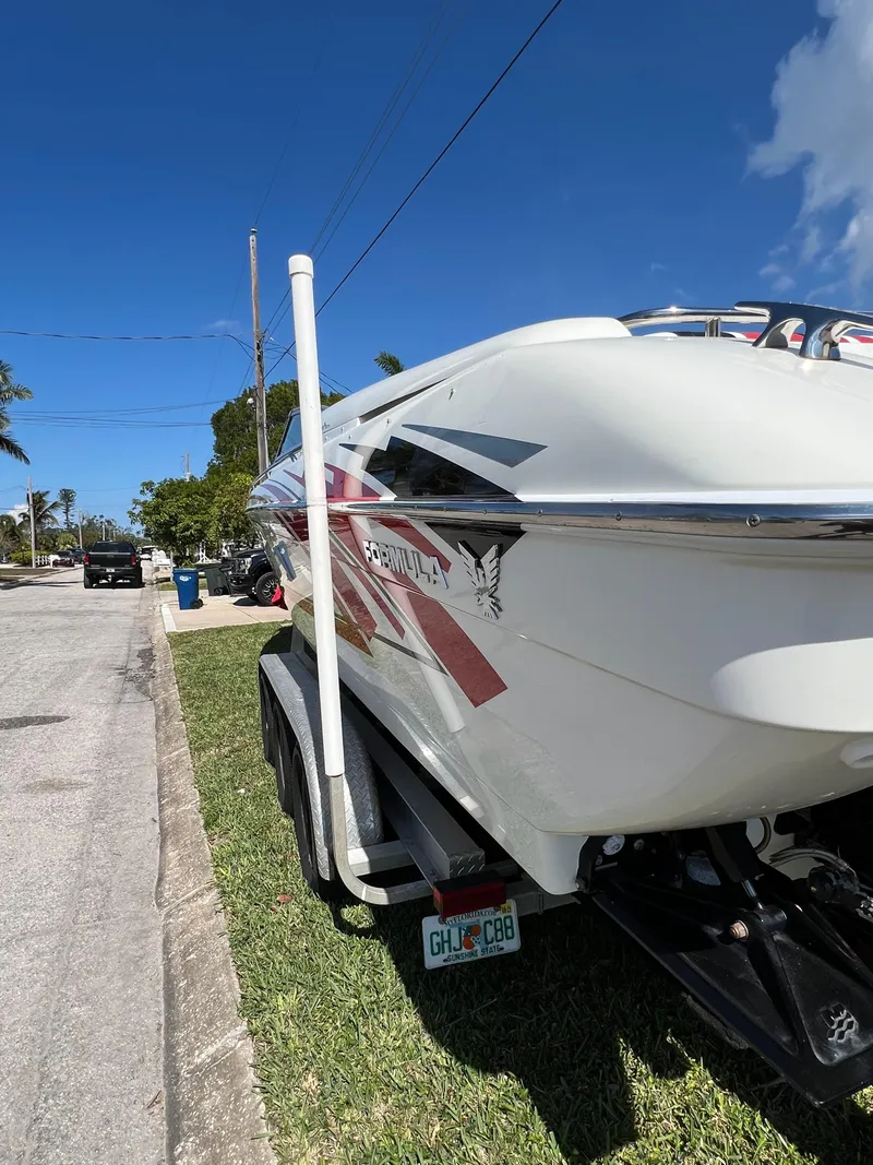 Slide: The Image of 2016 Formula 353 FASTech boat on trailer, parked on a sunny street. - 9