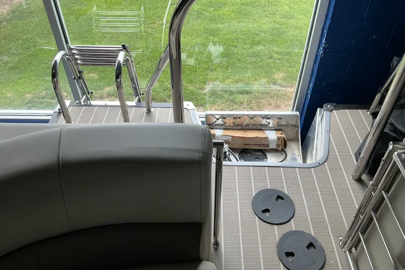 Slide: The Image of Interior view of 2026 Manitou 25 Encore RF SHP boat with seating and ladder. - 4