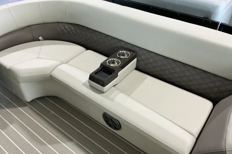 Slide: The Image of Luxurious seating on 2026 Manitou 25 Encore RF SHP boat with cup holders and quilted upholstery. - 7