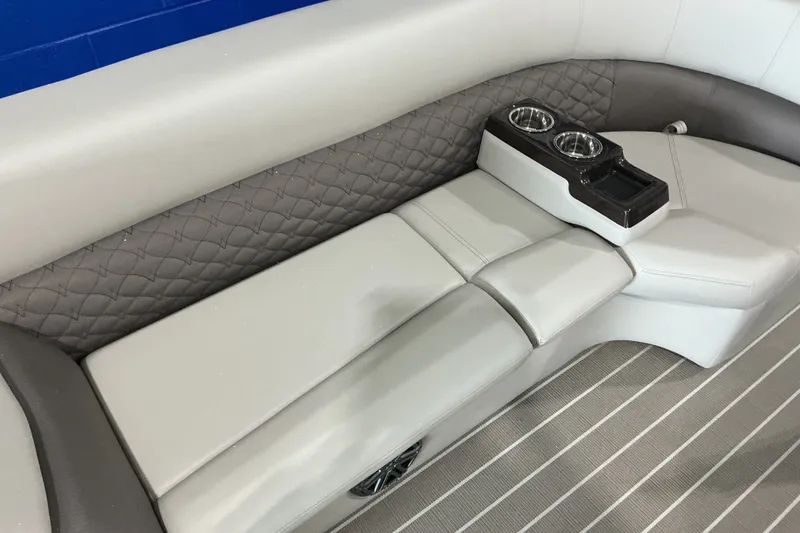 Slide: The Image of Luxurious seating with cup holders in 2026 Manitou 25 Encore RF SHP boat interior. - 9