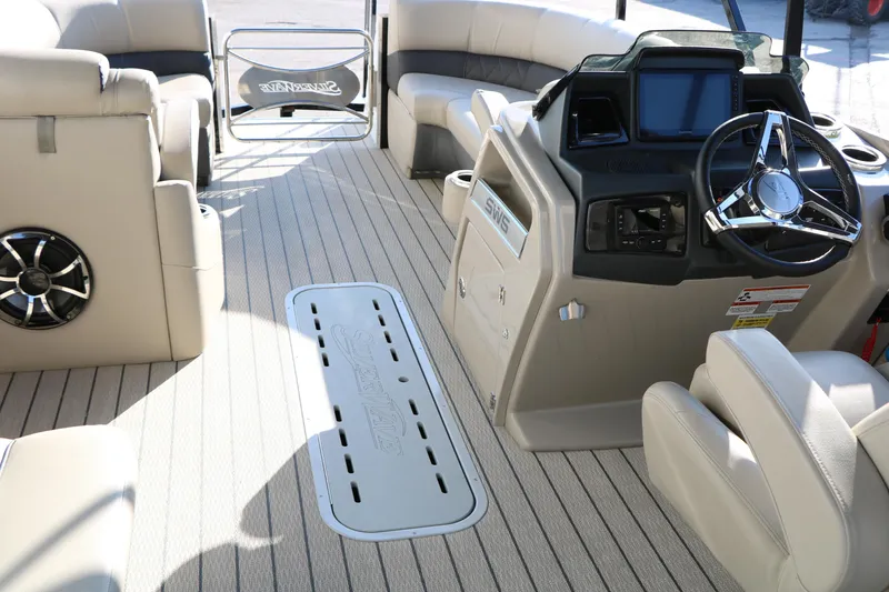 Slide: The Image of Interior of 2023 Silver Wave 2410 SW5 RLP boat with beige seating and modern dashboard. - 34