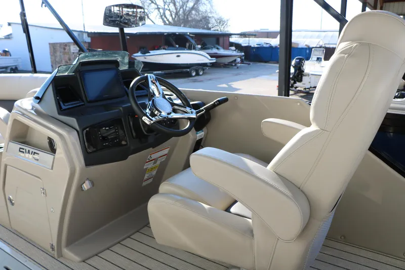 Slide: The Image of 2023 Silver Wave 2410 SW5 RLP boat interior with steering wheel and captain's chair. - 42
