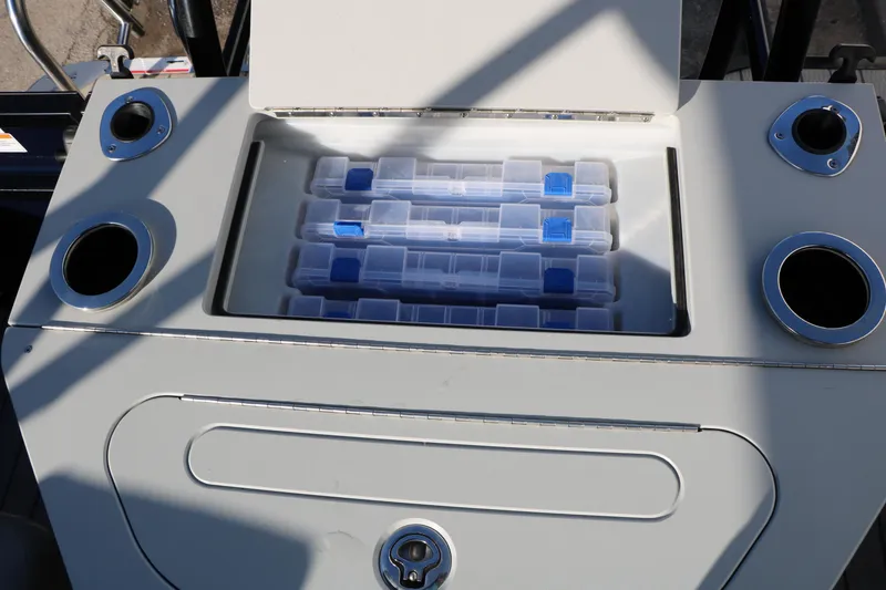 Slide: The Image of 2023 Silver Wave 2410 SW5 RLP boat storage compartment with organized tackle boxes. - 46