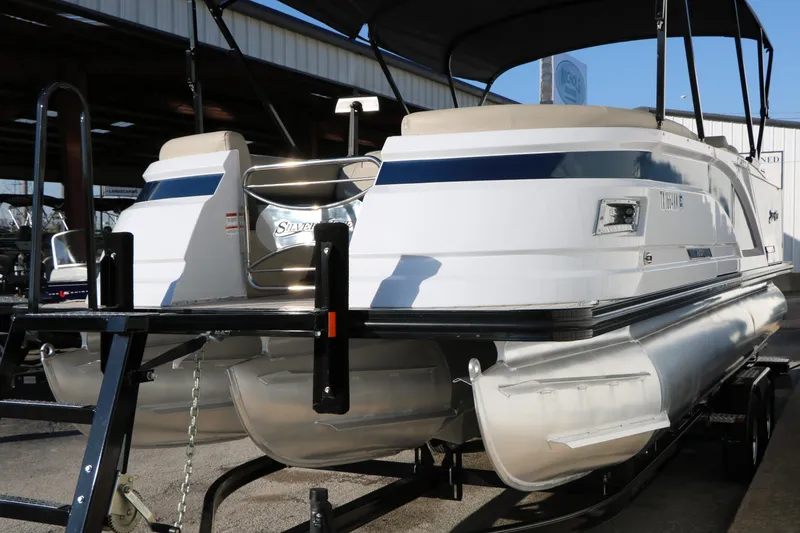 Slide: The Image of 2023 Silver Wave 2410 SW5 RLP pontoon boat on trailer, under covered storage. - 6