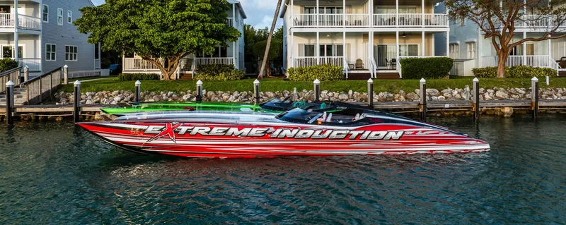 Slide: The Image of Red and white MTI 48 speedboat docked near waterfront homes, 2019 model. - 10