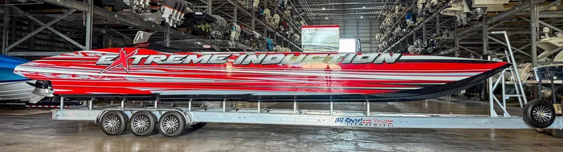 Slide: The Image of 2019 MTI 48 powerboat with "Extreme Induction" graphics on a trailer in a storage facility. - 14