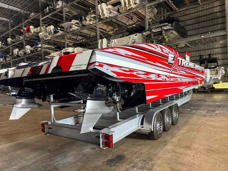 Slide: The Image of 2019 MTI 48 powerboat with red and white design on a trailer in a storage facility. - 16
