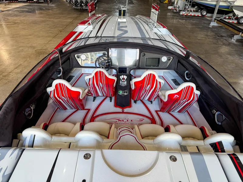 Slide: The Image of Luxurious 2019 MTI 48 speedboat interior with red and white seating, advanced dashboard controls. - 23