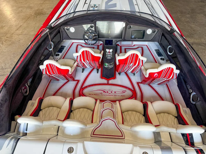 Slide: The Image of Luxurious 2019 MTI 48 boat interior with red and white seating and advanced dashboard. - 24