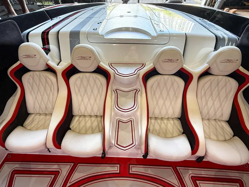 Slide: The Image of Luxurious MTI 48 boat interior with white and red diamond-stitched seats, 2019 model. - 28