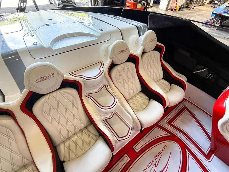 Slide: The Image of Luxurious interior of a 2019 MTI 48 boat with white and red seating. - 29