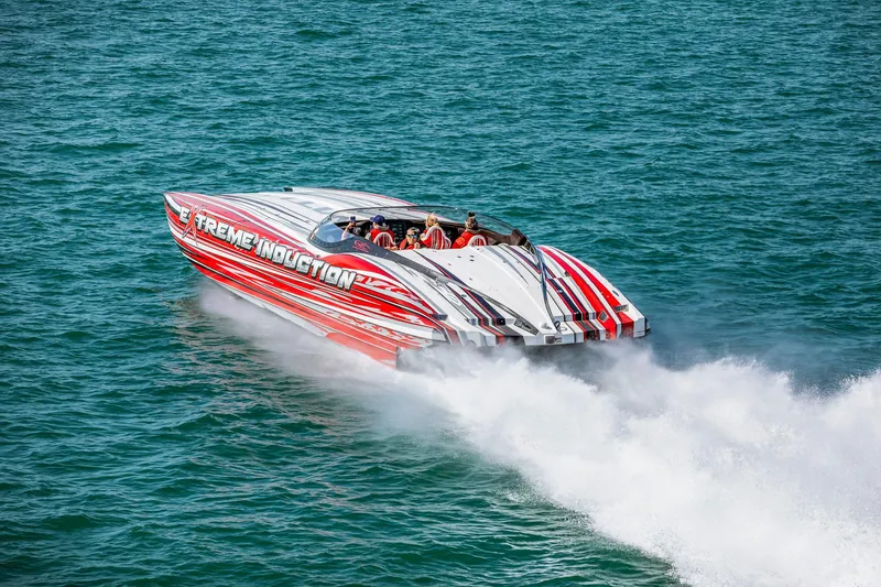 Slide: The Image of High-speed MTI 48 powerboat, 2019 model, with vibrant red and white design on open water. - 3