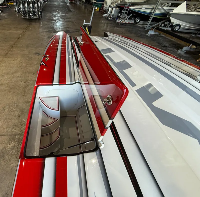 Slide: The Image of Red and white MTI 48 boat with open hatch, stored indoors, 2019 model. - 31