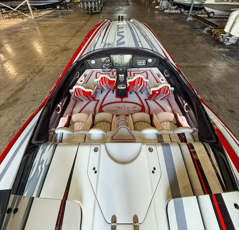 Slide: The Image of Interior of a 2019 MTI 48 speedboat with red and white seating. - 48
