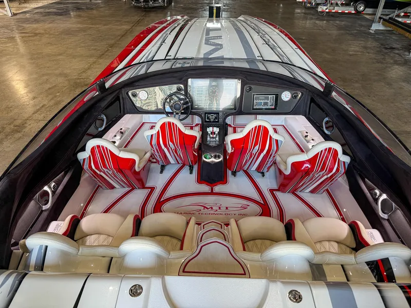 Slide: The Image of 2019 MTI 48 boat interior with red and white seating. - 49