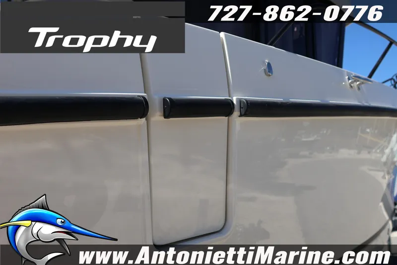 Slide: The Image of 2026 Bayliner Trophy T25 Pilothouse boat side view with contact details and logo. - 10