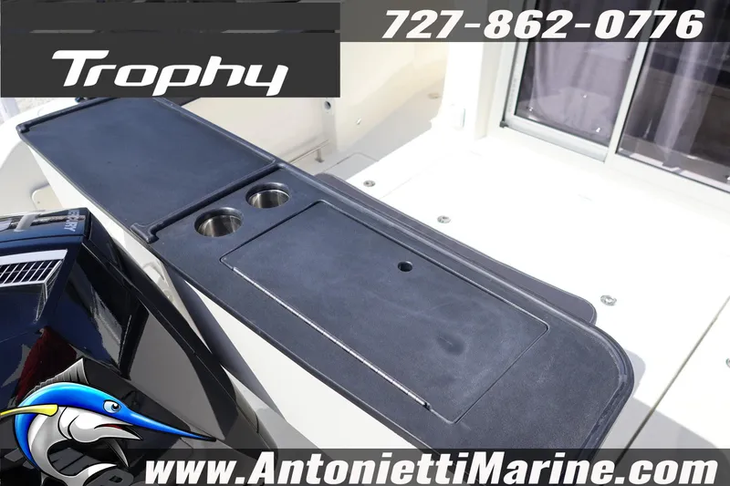 Slide: The Image of 2026 Bayliner Trophy T25 Pilothouse boat deck with storage and cup holders. - 12
