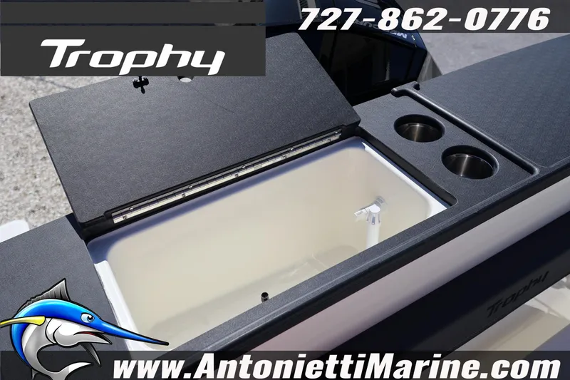 Slide: The Image of Bayliner Trophy T25 Pilothouse 2026 boat interior with storage and cup holders. - 14