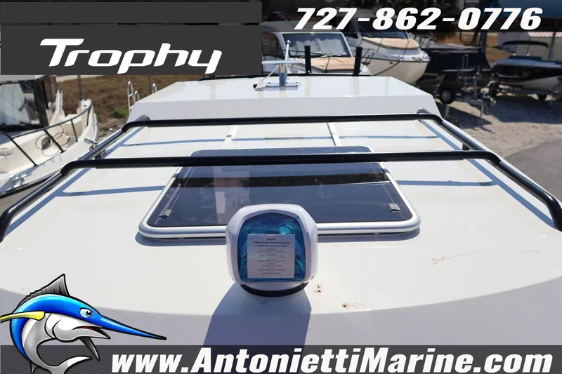 Slide: The Image of 2026 Bayliner Trophy T25 Pilothouse boat roof with contact details and logo. - 23